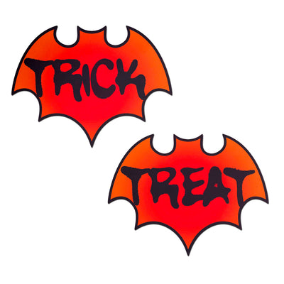 reddish orange bat shaped nipple covers, one says trick the other says treat in spooky black print