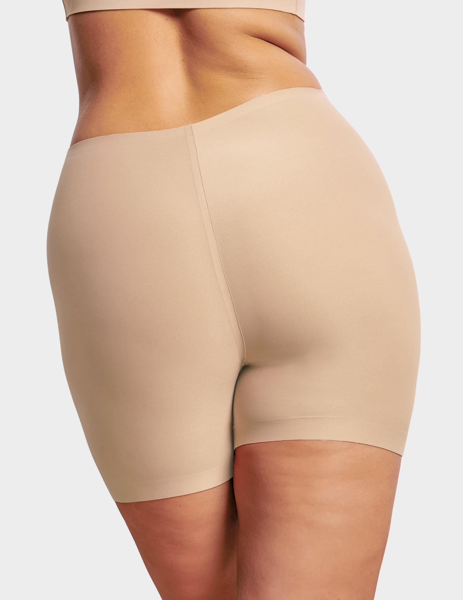 Back view of a model wearing Evelyn & Bobbie girlshort in Sand