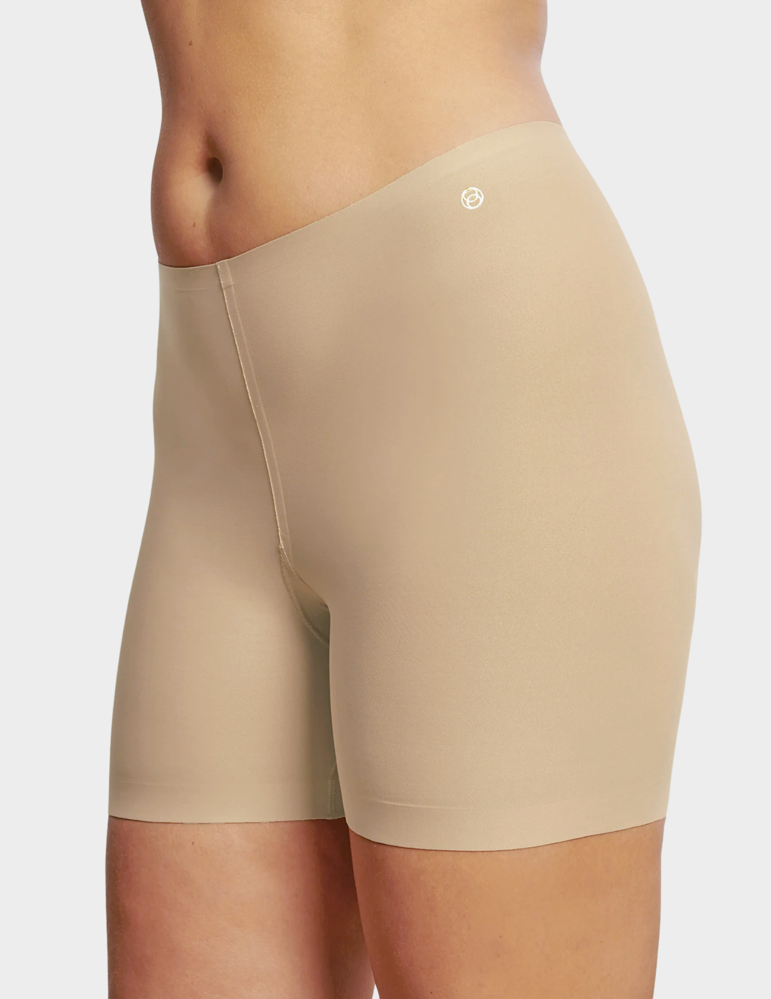 Side view of a model wearing Evelyn & Bobbie girlshort in Sand