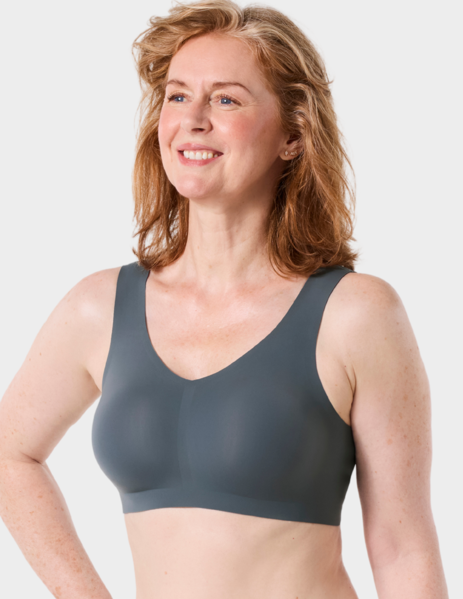 Side view of a model wearing Evelyn & Bobbie Defy bra in Slate Grey