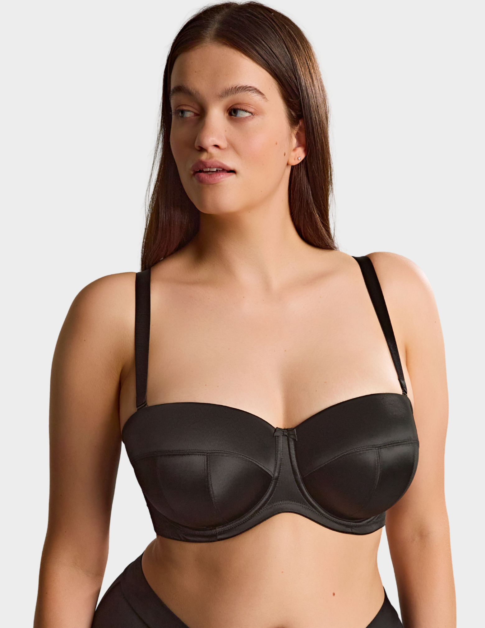 Front view of a model wearing Sculptresse Dana strapless bra in Black with straps attached