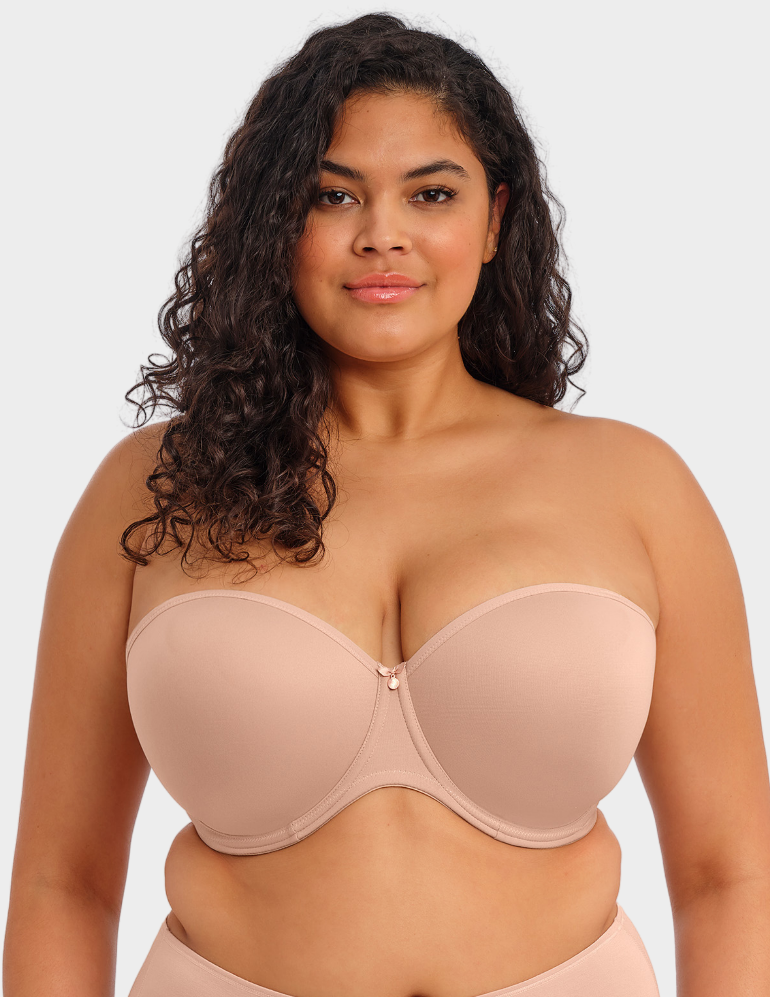 Front view of a model wearing Elomi Smooth strapless bra in Sahara
