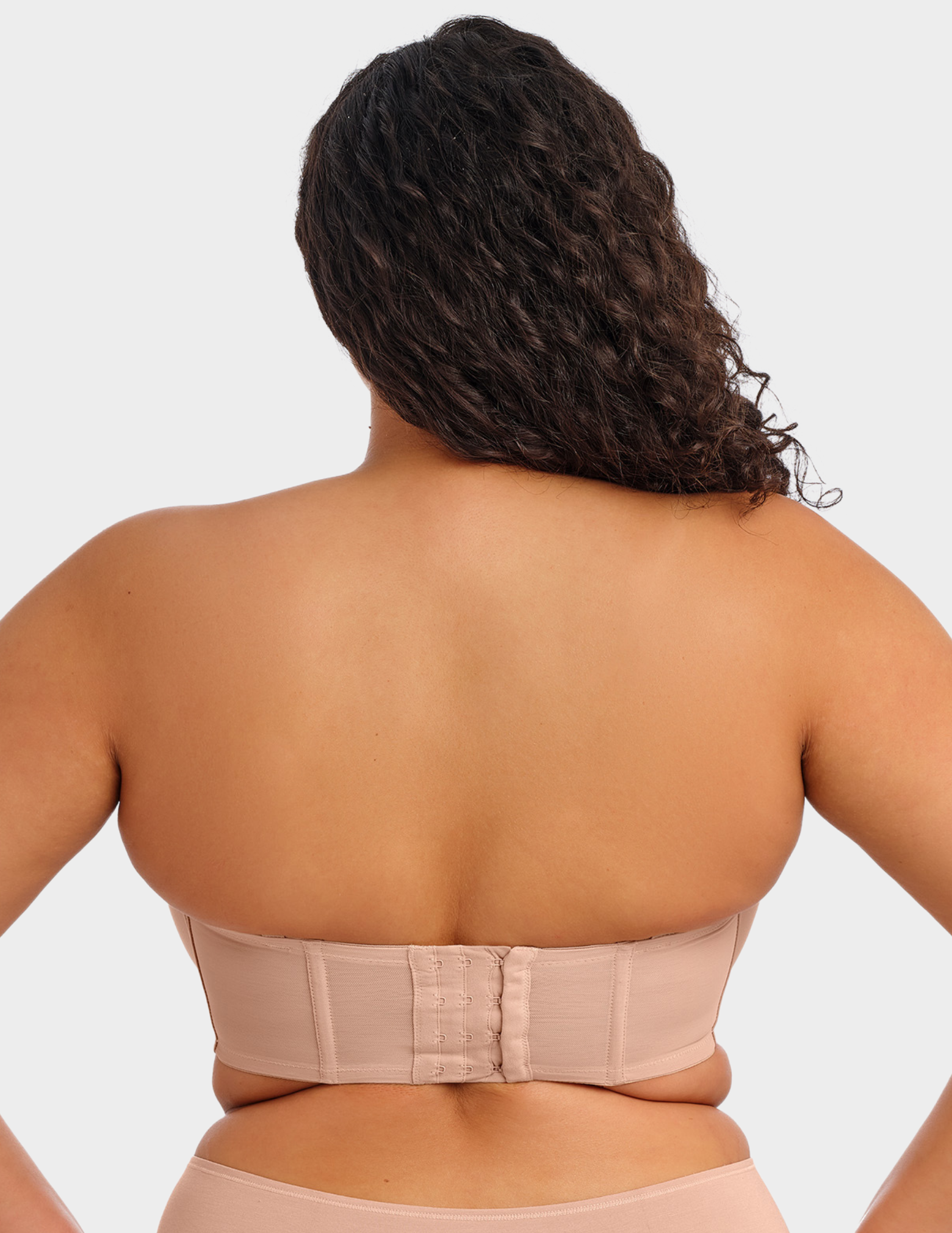 Back view of a model wearing Elomi Smooth strapless bra in Sahara