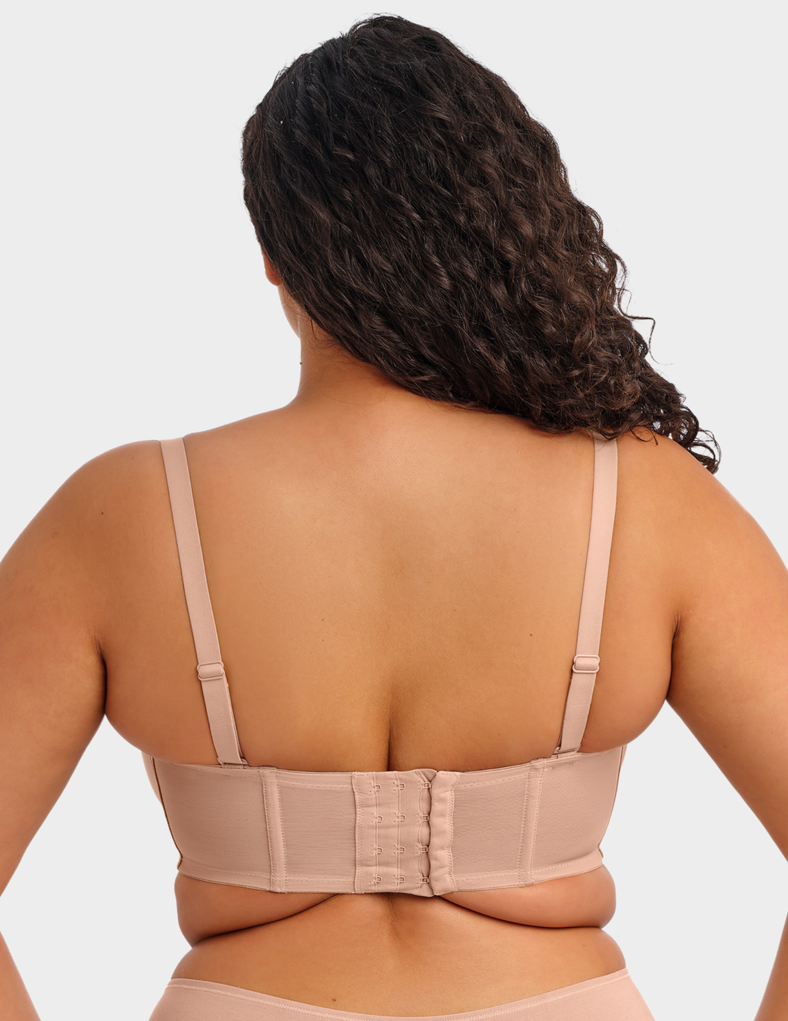Back view of a model wearing Elomi Smooth strapless bra in Sahara with straps attached