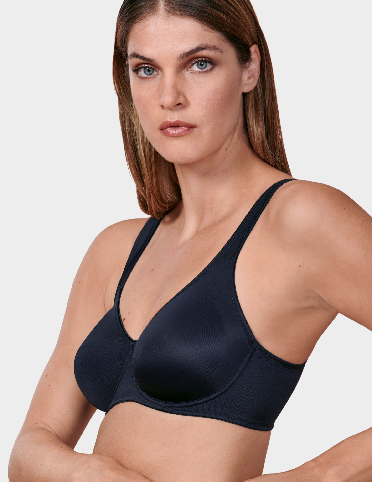 Side view of a model wearing a black Anita Twin bra