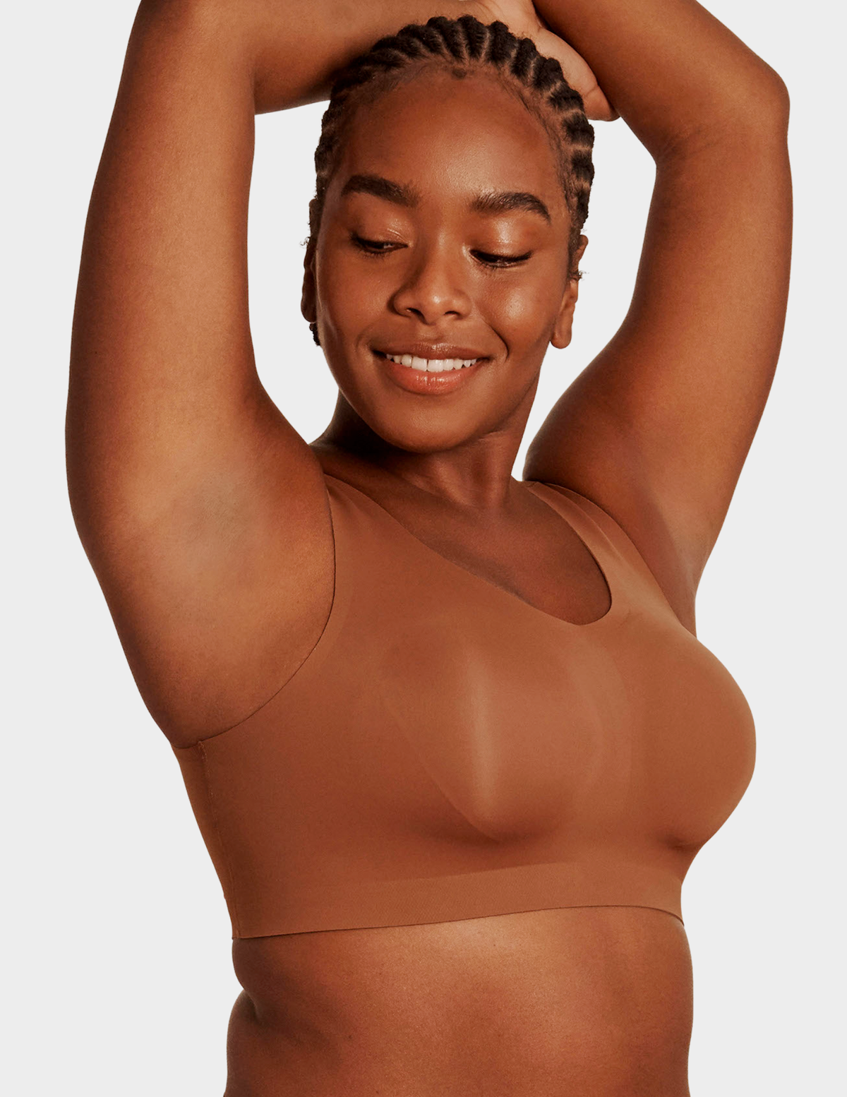Side view of a model wearing Evelyn & Bobbie Defy bra in Clay