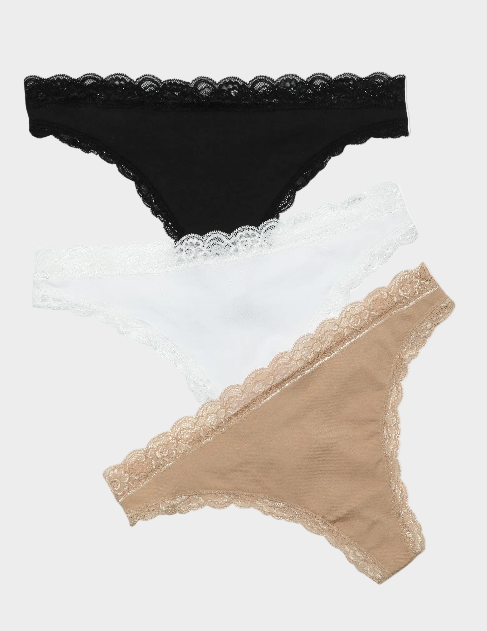 Black, white, and beige lace-trimmed underwear on a white background