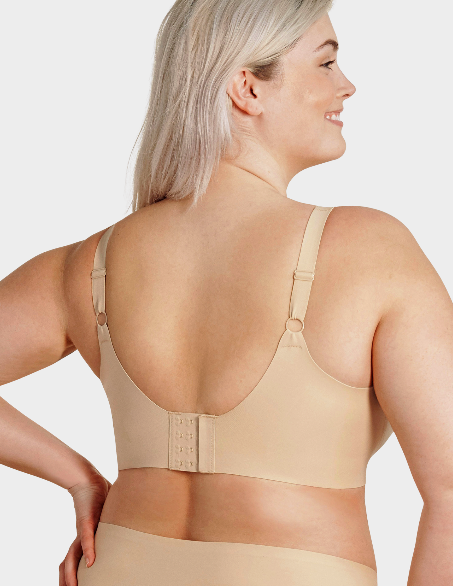 Back view of a model wearing Evelyn & Bobbie Beyond bra in Sand