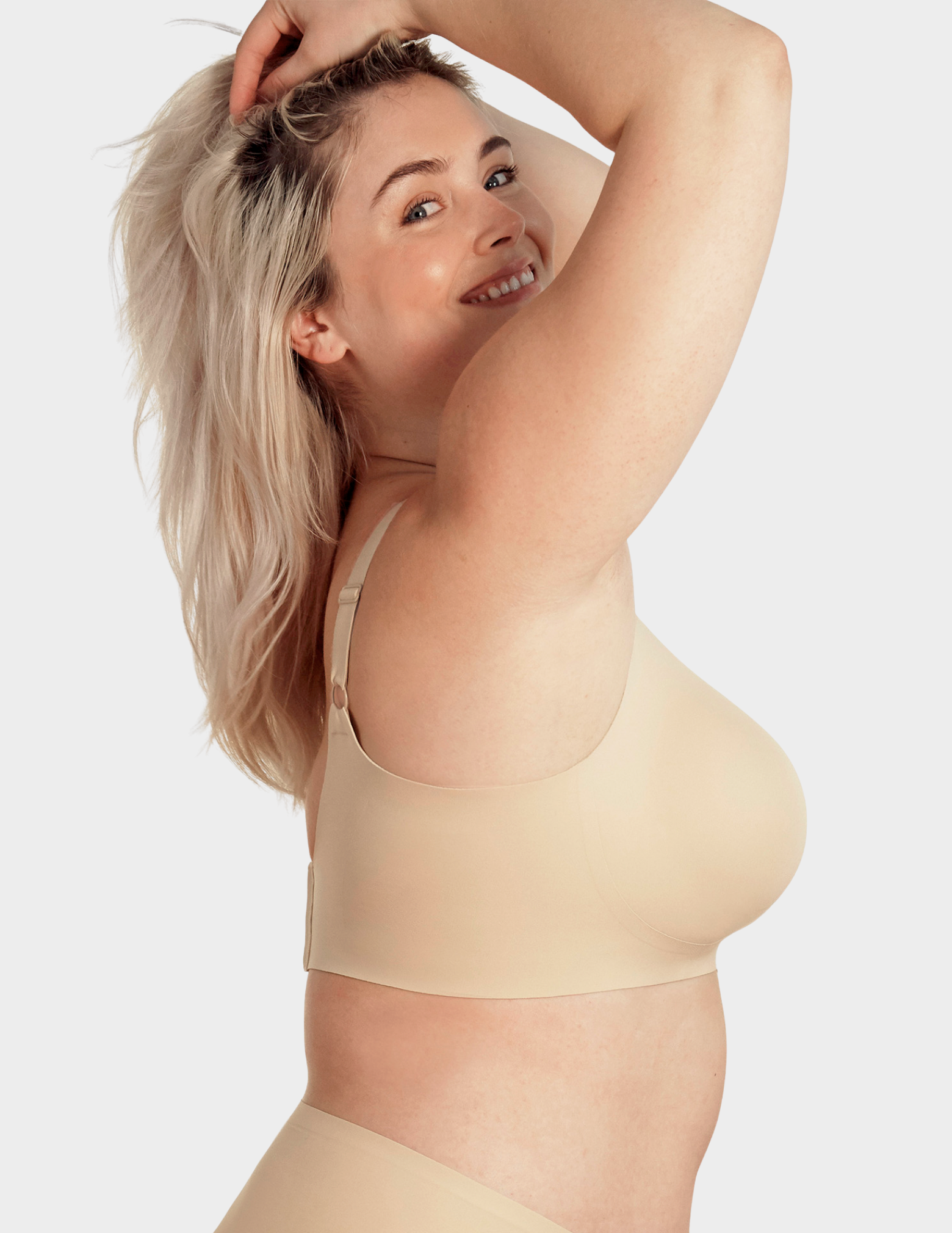 Side view of a model wearing Evelyn & Bobbie Beyond bra in Sand