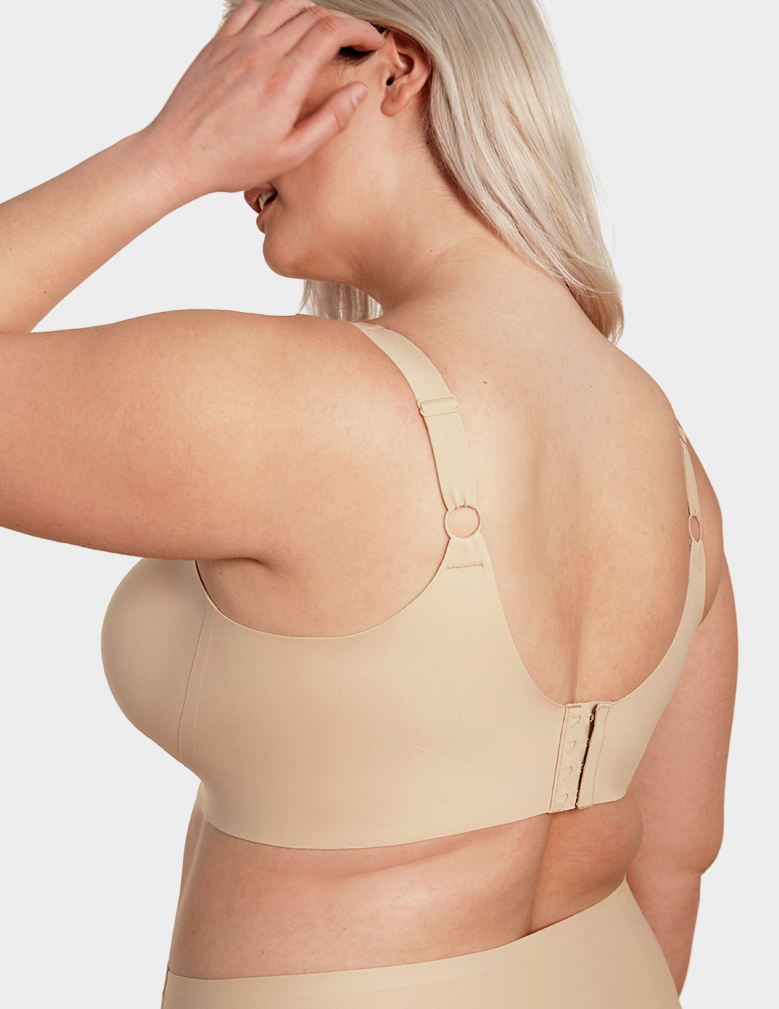 Back view of a model wearing Evelyn & Bobbie Beyond bra in Sand