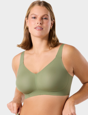 Front view of a model wearing Evelyn & Bobbie Beyond bra in Matcha