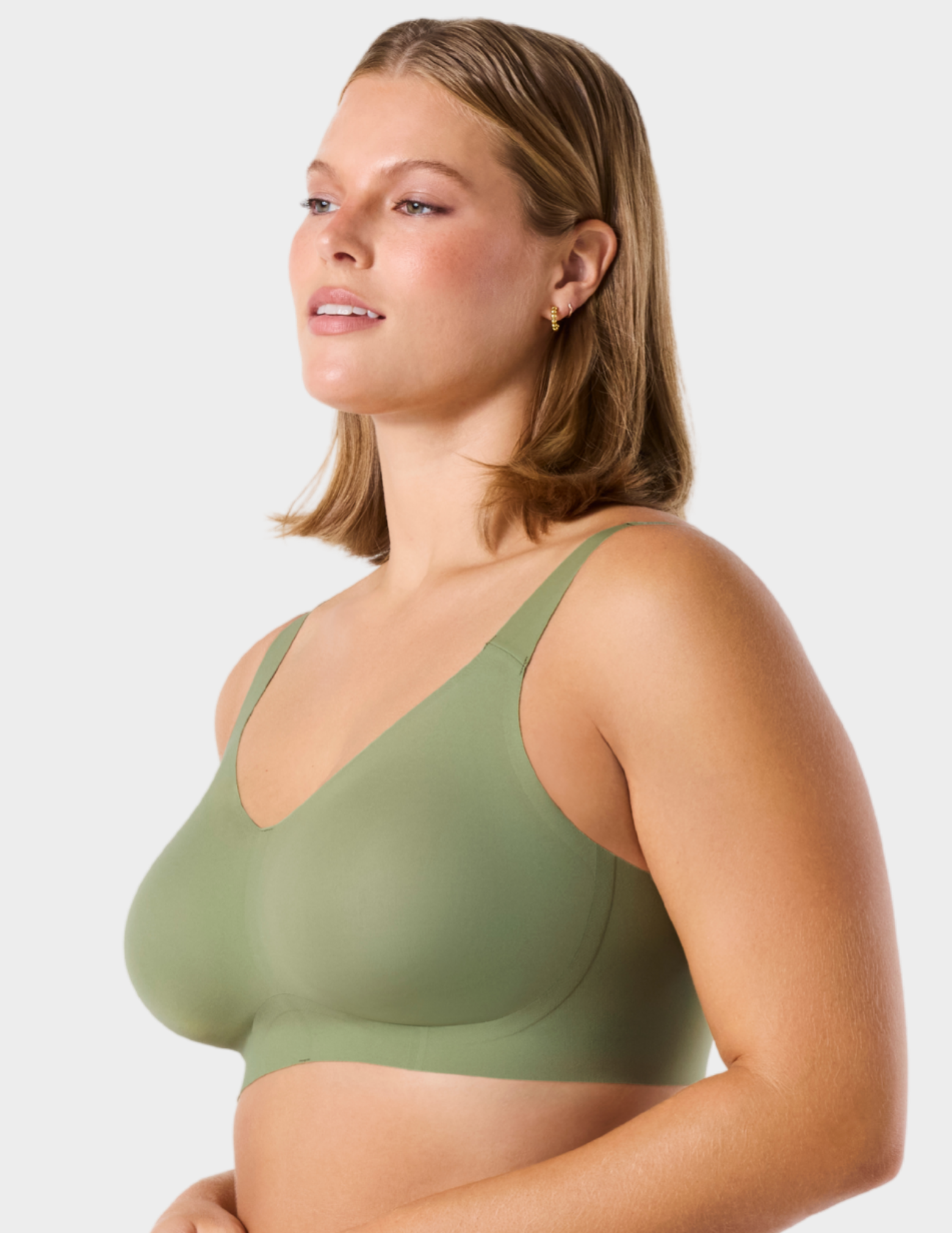 Side view of a model wearing Evelyn & Bobbie Beyond bra in Matcha