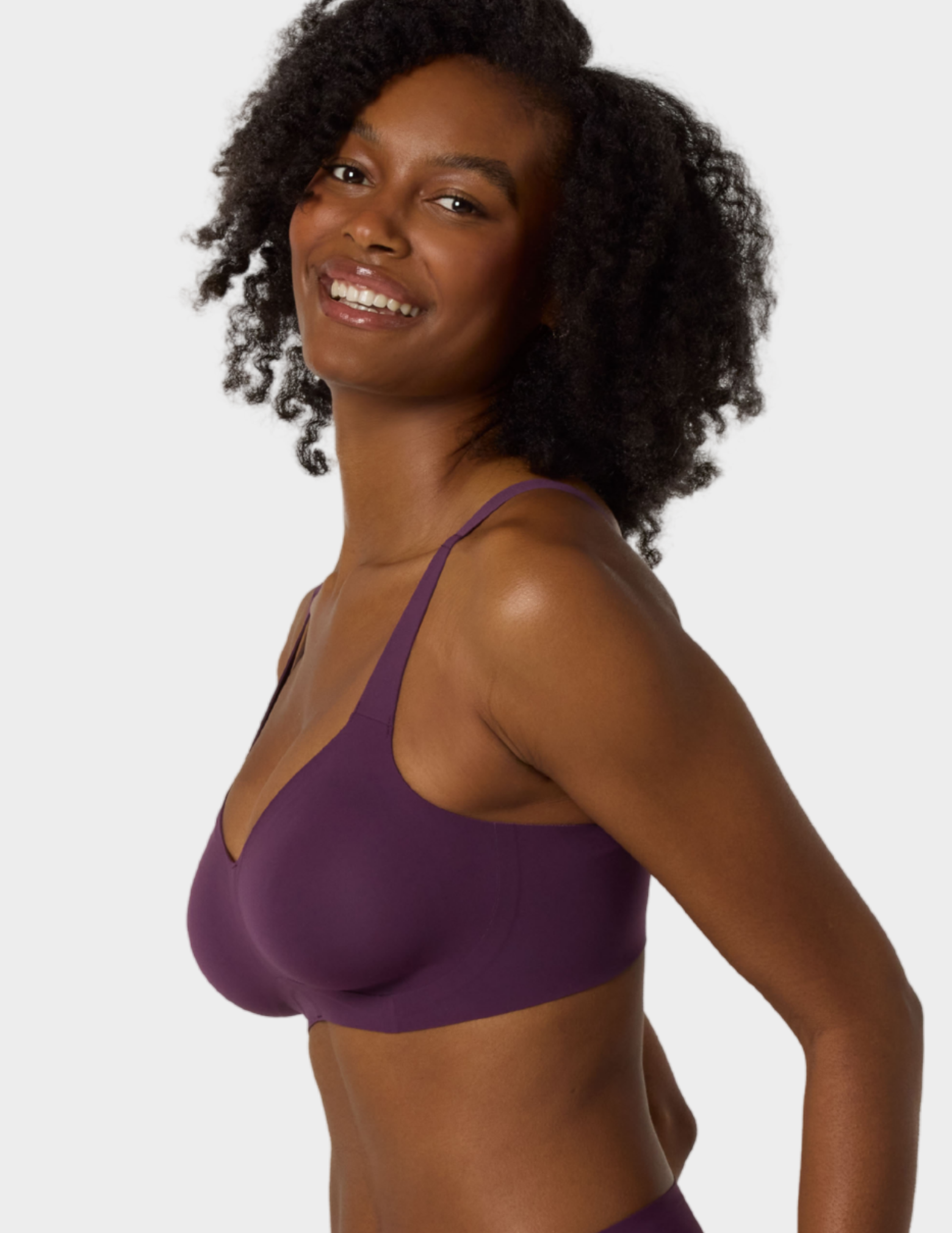 Side view of a model wearing Evelyn & Bobbie Beyond bra in Plum