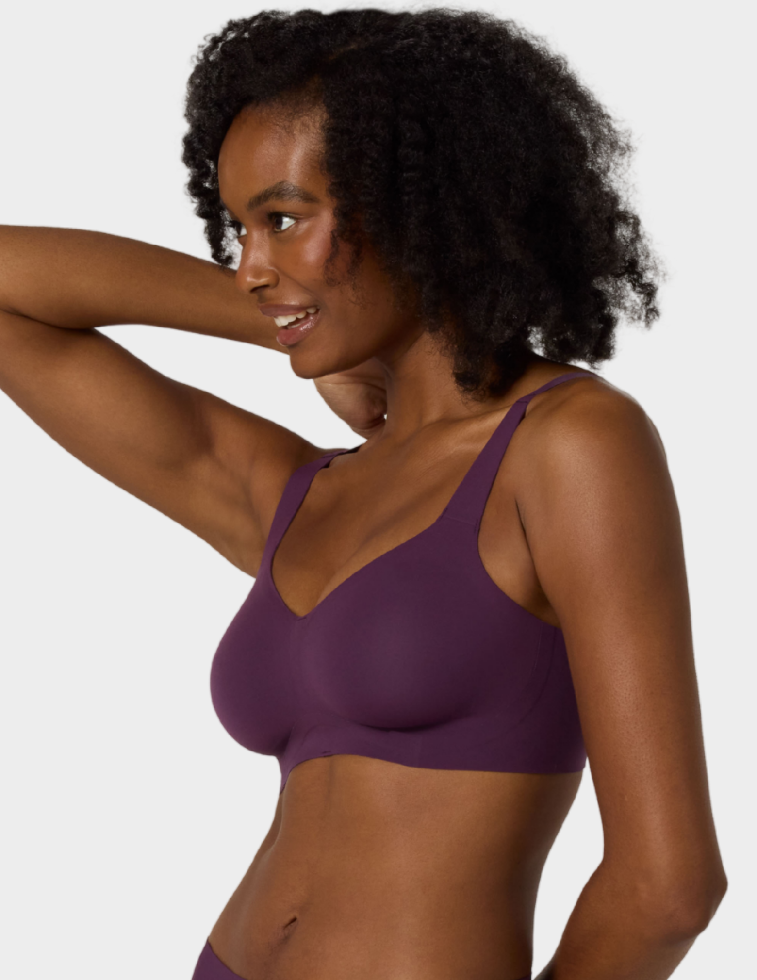 Side view of a model wearing Evelyn & Bobbie Beyond bra in Plum