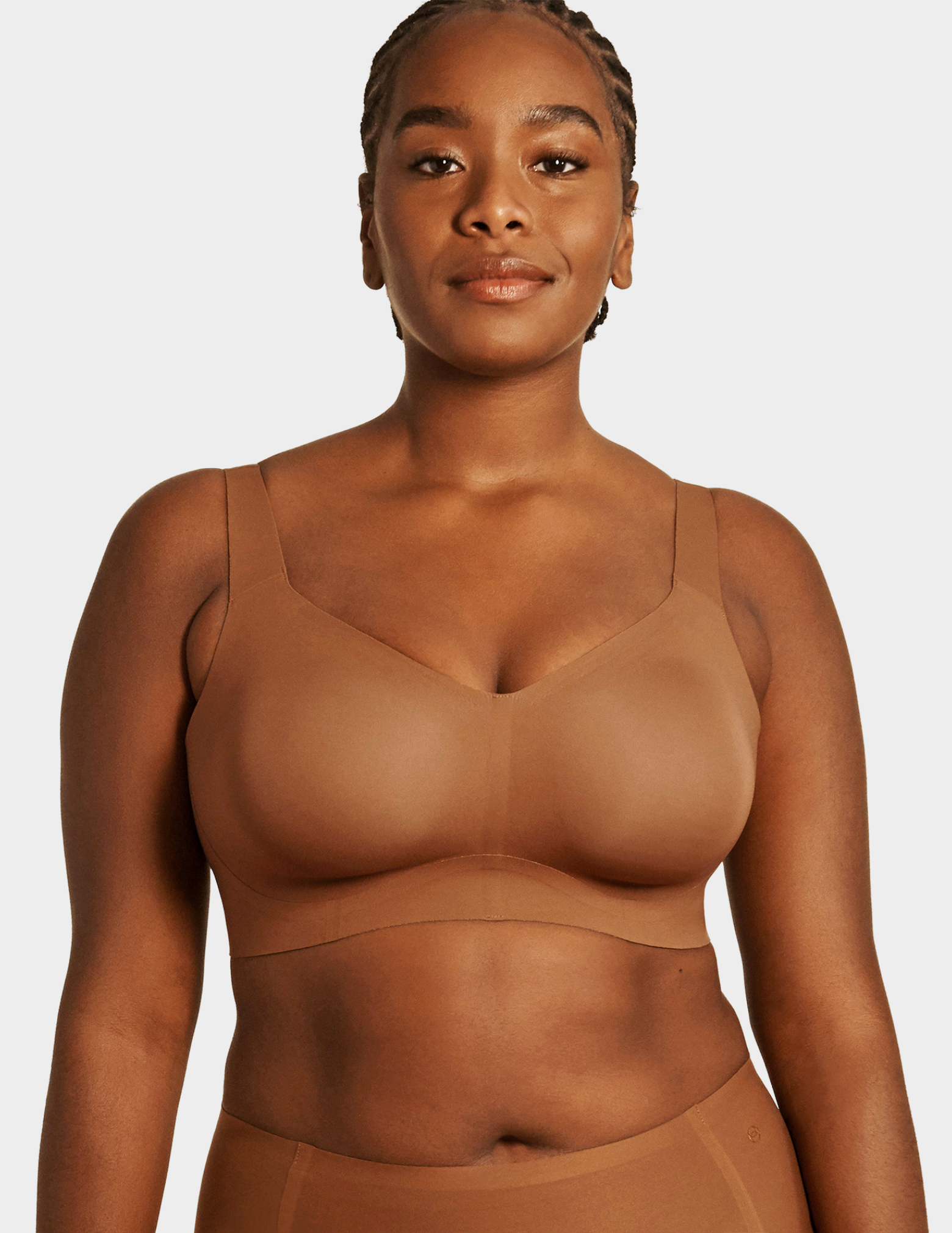 Front view of a model wearing Evelyn & Bobbie Beyond bra in Clay