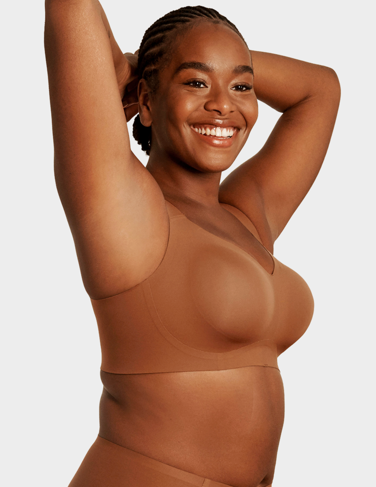 Side view of a model wearing Evelyn & Bobbie Beyond bra in Clay