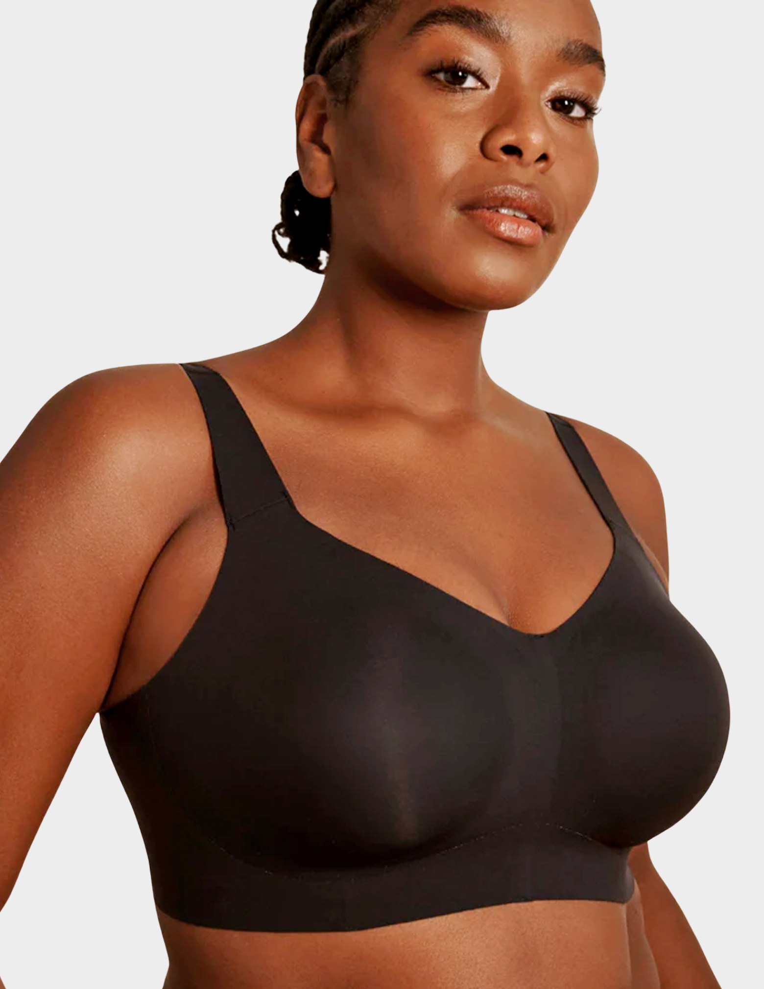 Close up side view of a model wearing Evelyn & Bobbie Beyond bra in Black