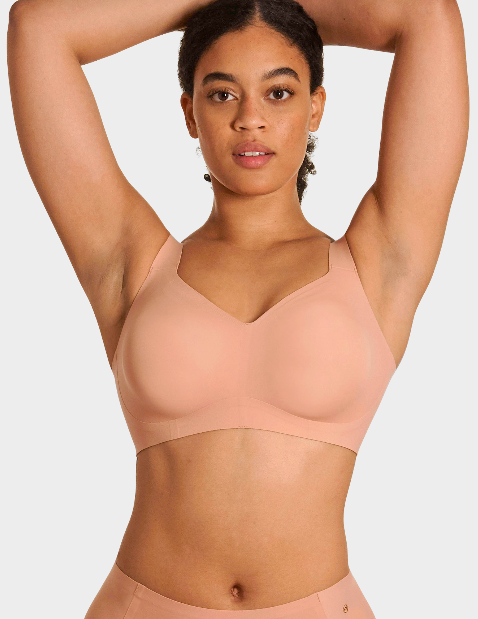 Front view of a model wearing Evelyn & Bobbie Beyond bra in Himalayan Salt