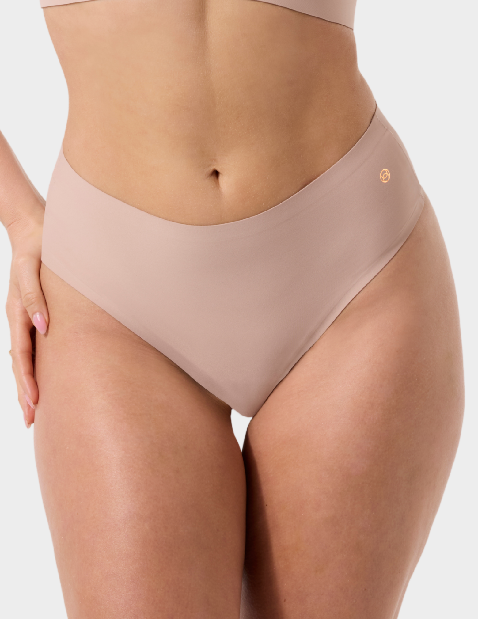 Front view of a model wearing Evelyn & Bobbie Seamless Thong in Petal Drift