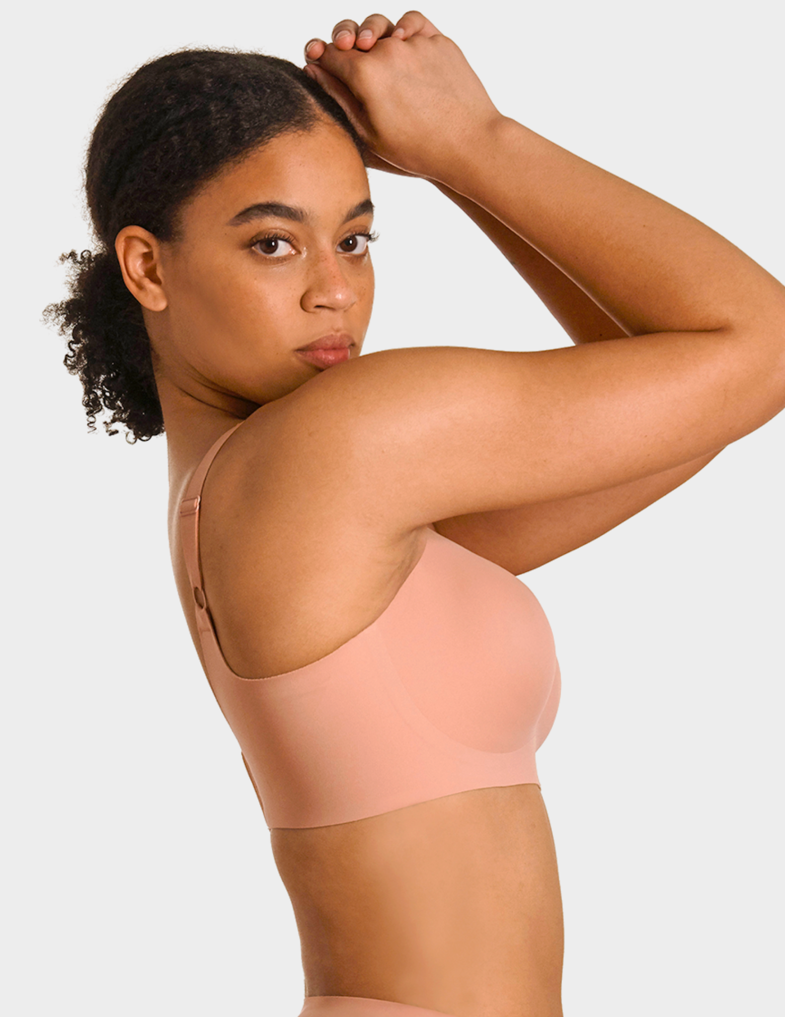 Side view of a model wearing Evelyn & Bobbie Beyond bra in Himalayan Salt