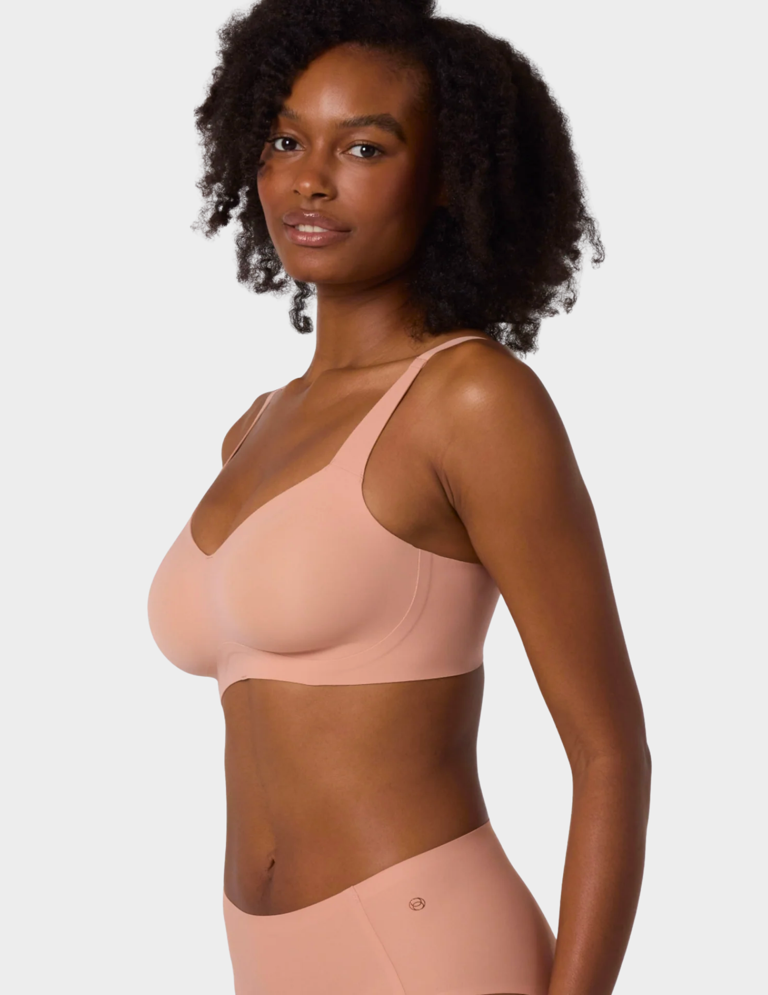 Side view of a model wearing Evelyn & Bobbie Beyond bra in Himalayan Salt