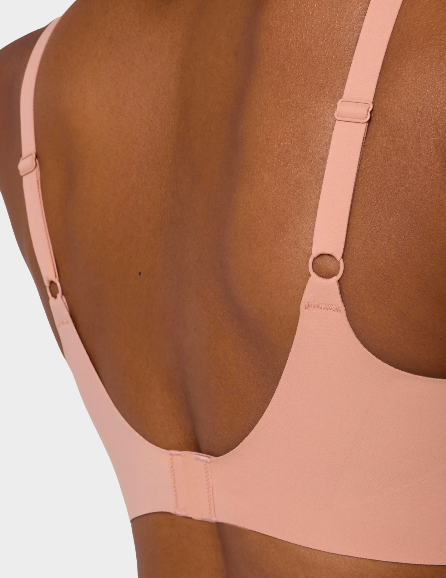 Close up back view of a model wearing Evelyn & Bobbie Beyond bra in Himalayan Salt