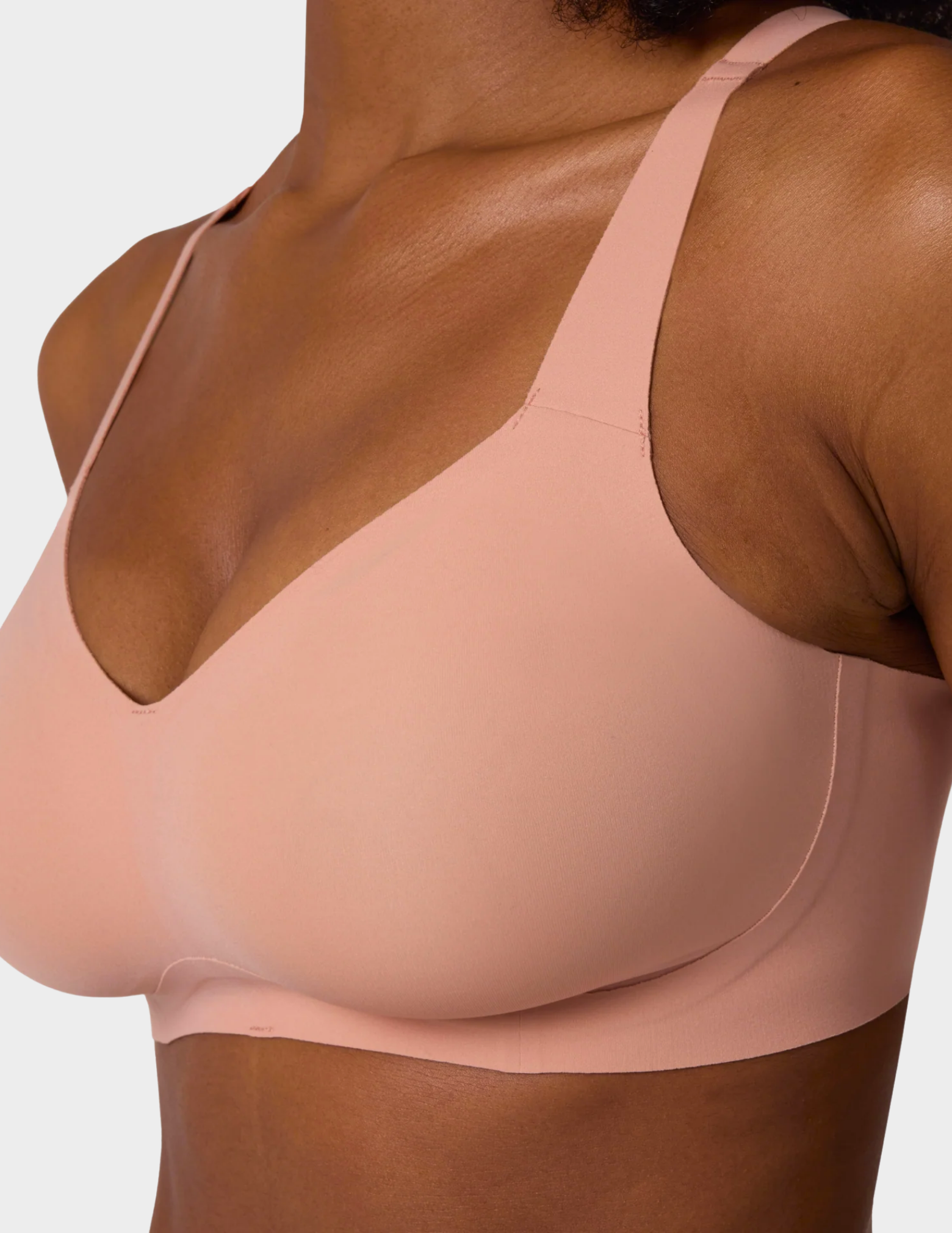 Close up side view of a model wearing Evelyn & Bobbie Beyond bra in Himalayan Salt