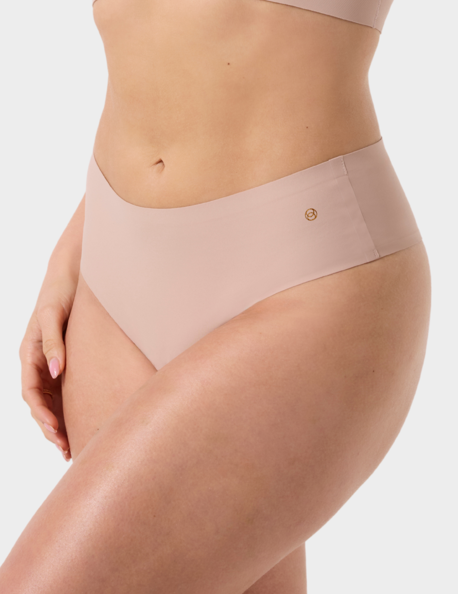 Side view of a model wearing Evelyn & Bobbie Seamless Thong in Petal Drift