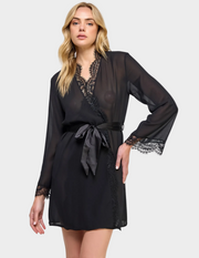 Front view of a model wearing a semi-sheer black robe with lace trim