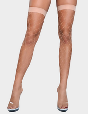 Front view of a model wearing beige fishnet thigh highs