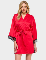 Front view of a model wearing a red satin robe with black lace trim