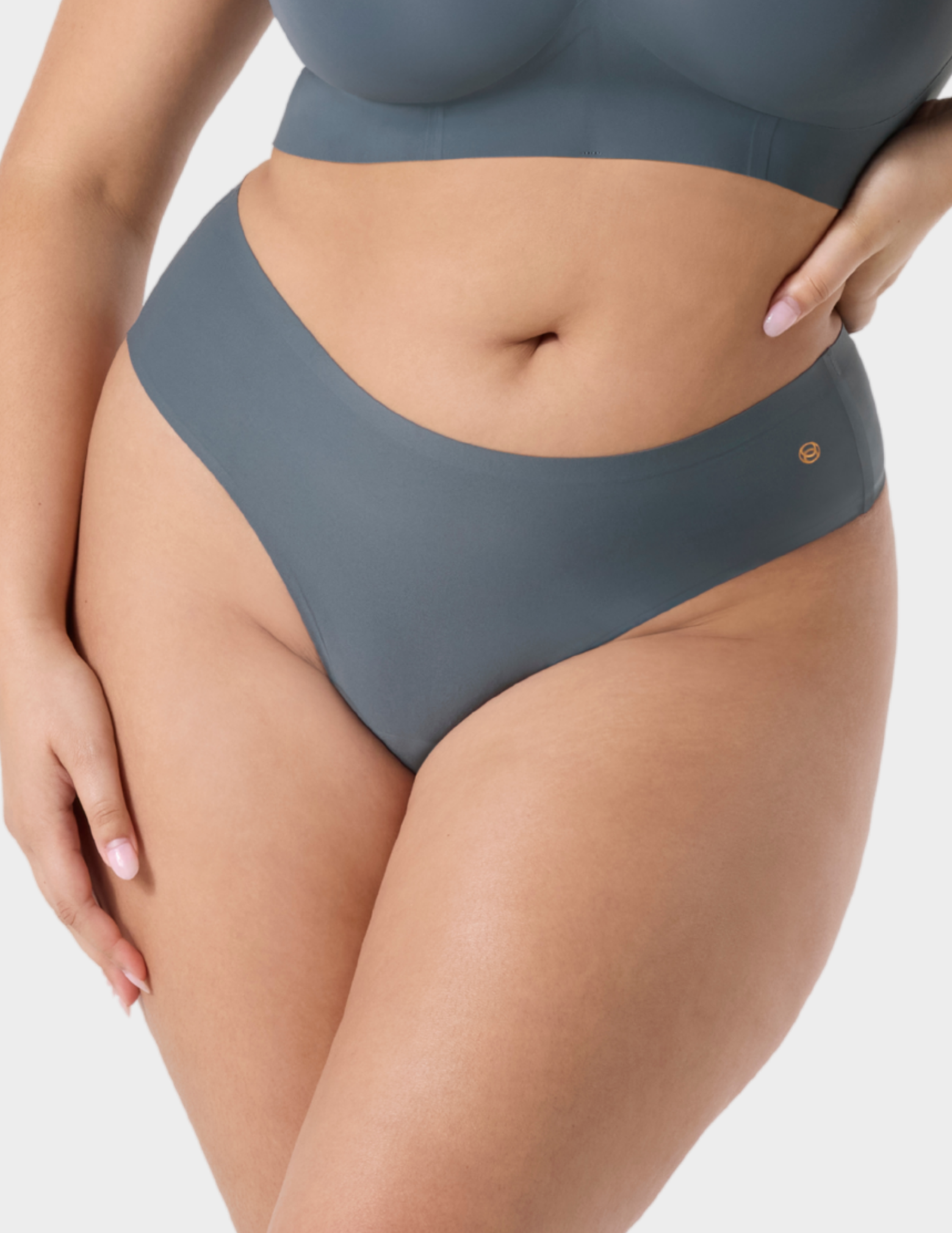 Front view of a model wearing Evelyn & Bobbie Seamless Thong in Slate Grey