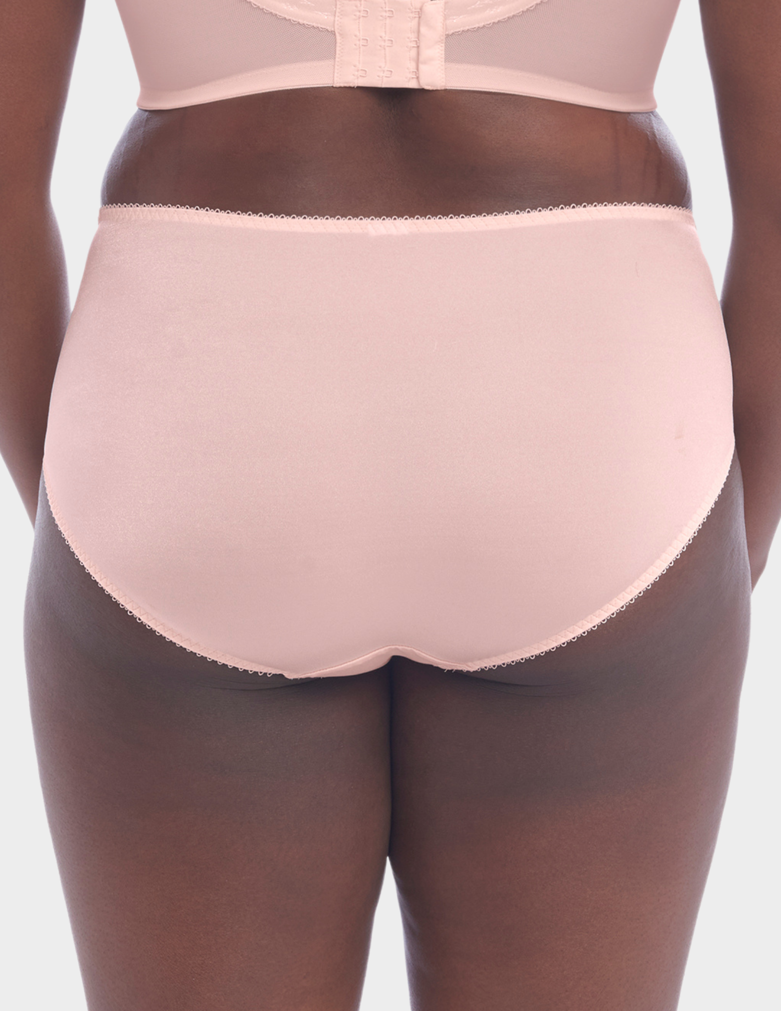 Back view of a model wearing Goddess Keira brief in Pearl Blush