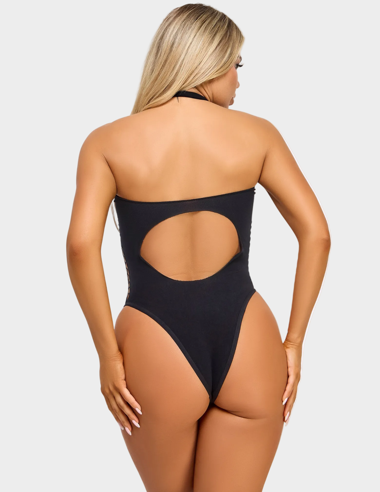 Back view of a model wearing a black bodysuit with cutout details