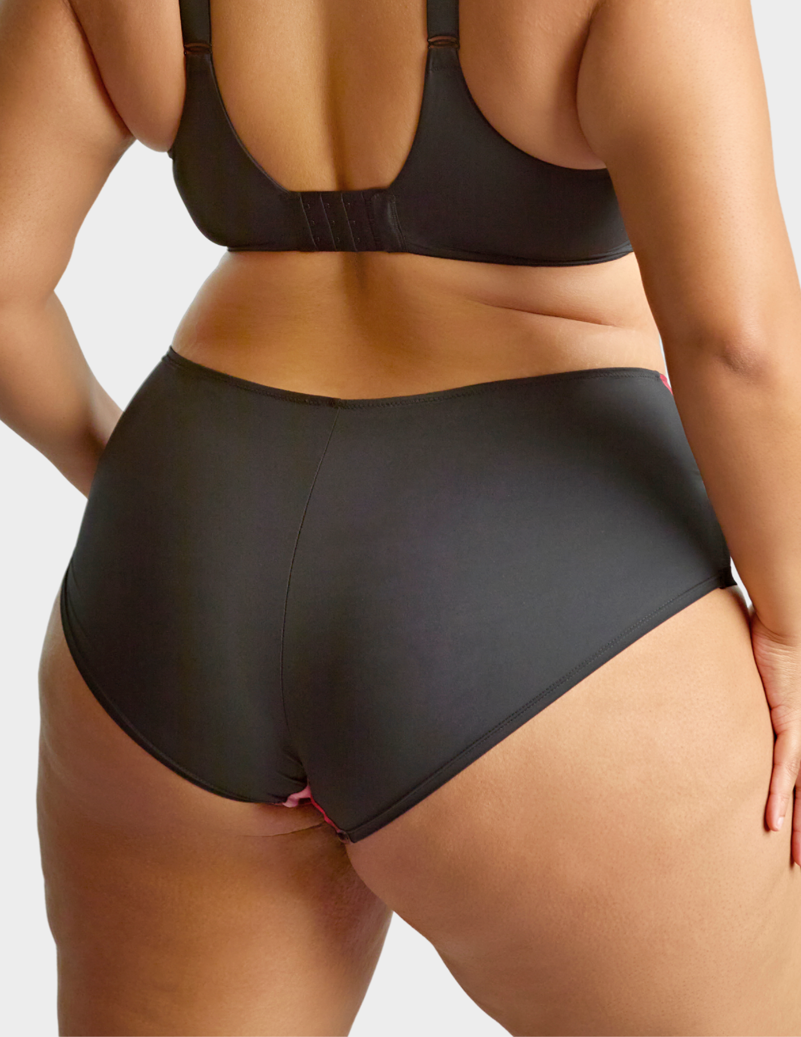 Back view of a model wearing Sculptresse Bliss brief in Rose Print