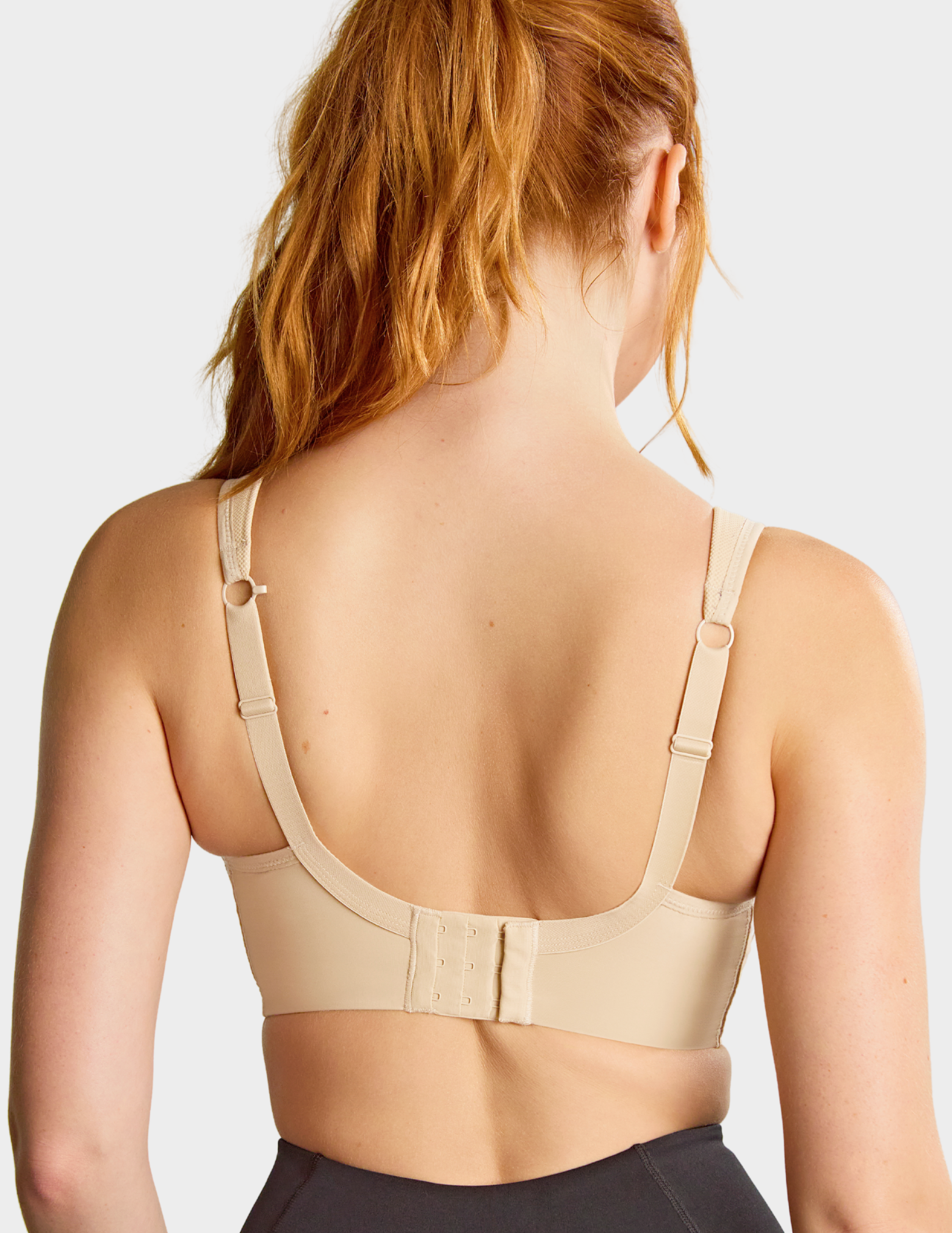Back view of a model wearing Panache Power sports bra in Latte