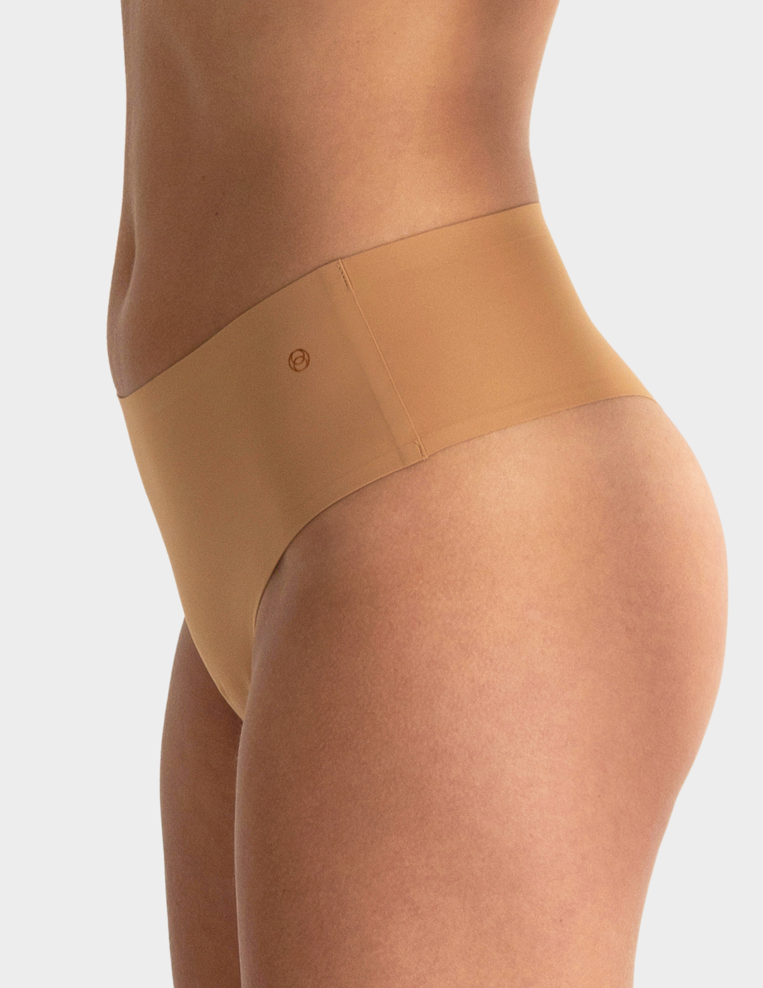 Side view of a model wearing Evelyn & Bobbie Seamless Thong in Mica