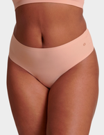 Front view of a model wearing Evelyn & Bobbie Seamless Thong in Himalayan Salt