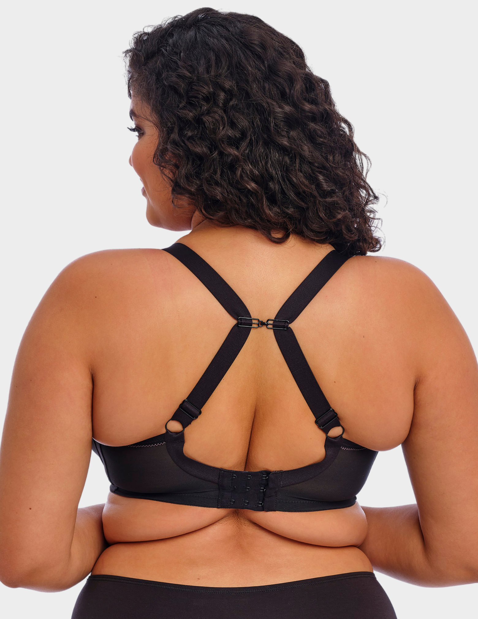 Back view of a model wearing Elomi Bijou plunge bra in black with straps hooked