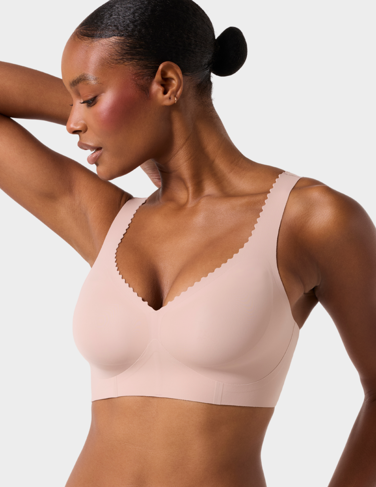 Side front view of a model wearing Evelyn & Bobbie Evelyn Bra in color Petal Drift