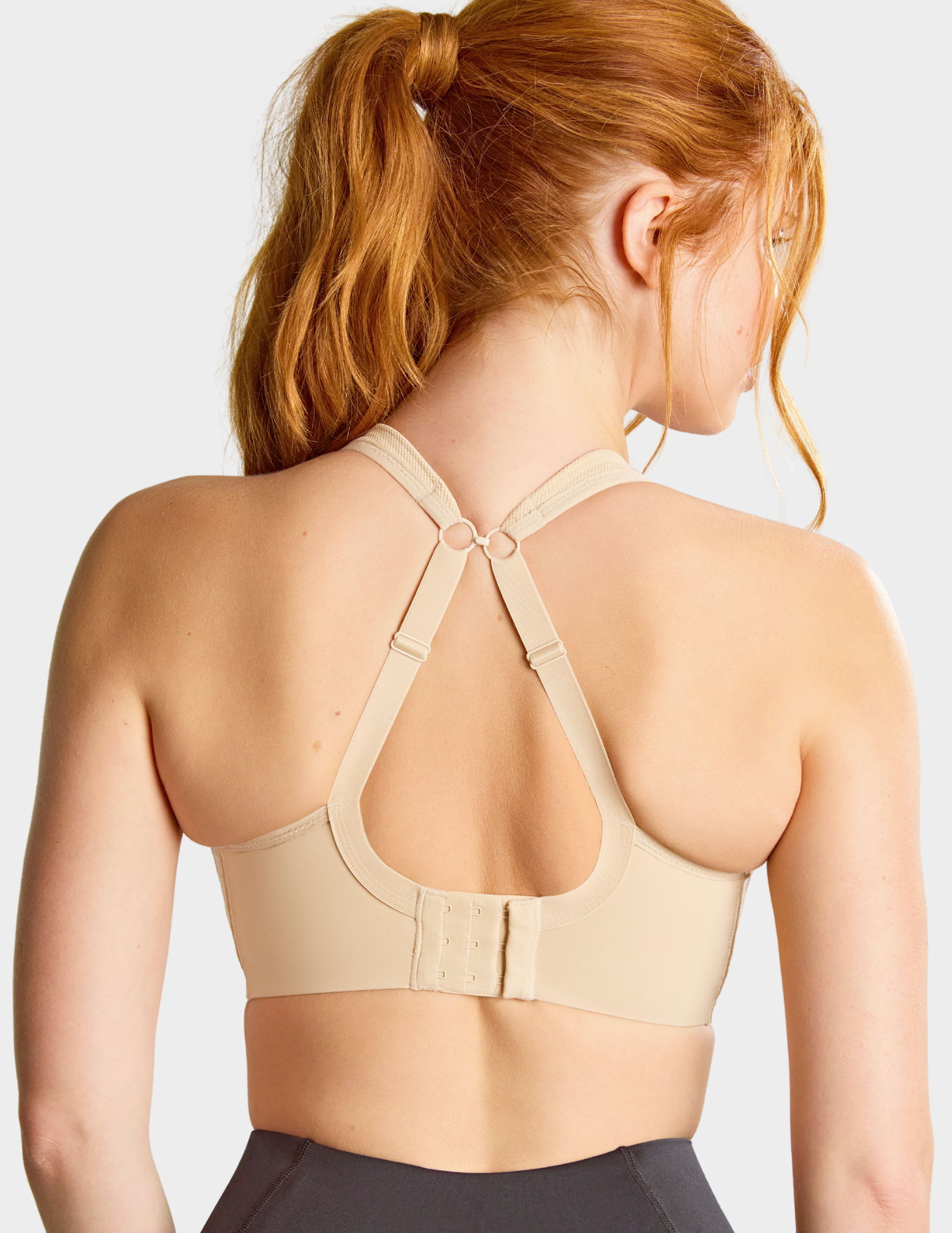 Back view of a model wearing Panache Power sports bra in Latte with straps hooked