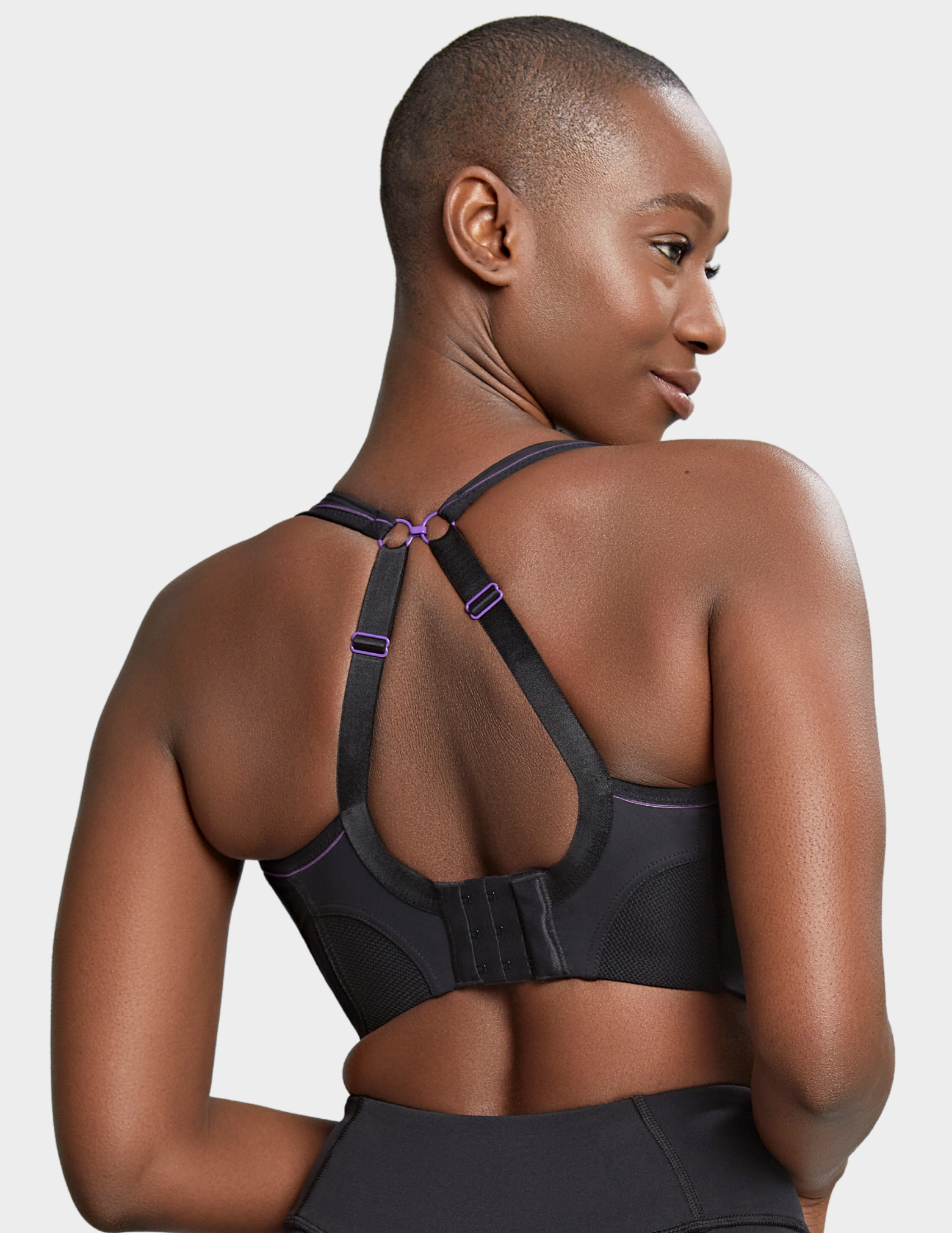 Back view of a model wearing Panache Non wired sports bra in Black with straps hooked