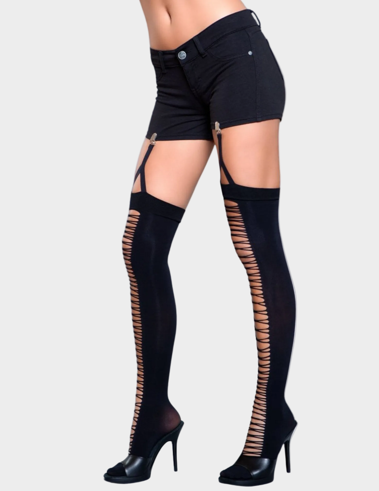Side view of a model wearing black clip on thigh highs with lace up detail