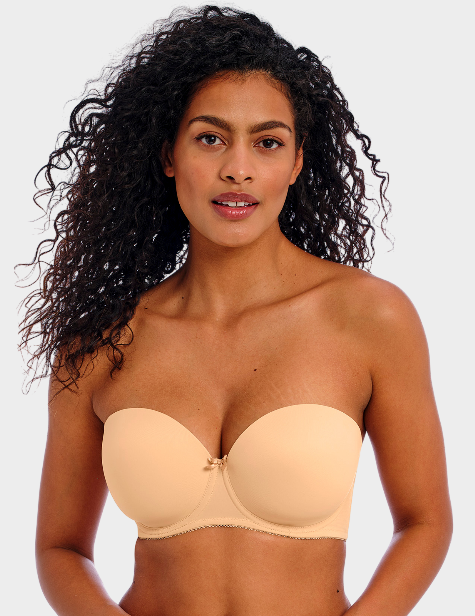 Front view of a model wearing Freya Deco strapless bra in Nude