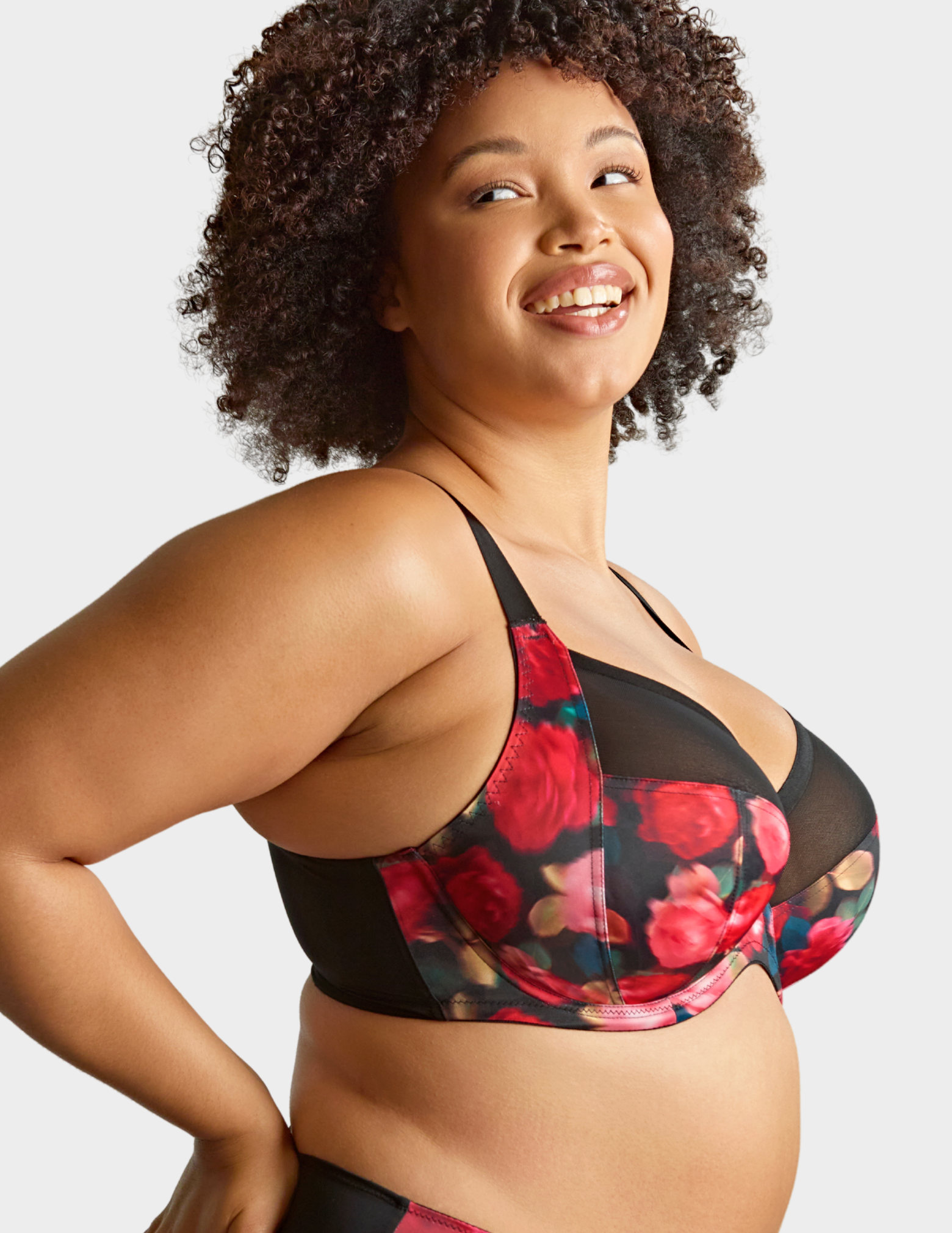 Side view of a model wearing Sculptresse Bliss bra in Rose Print