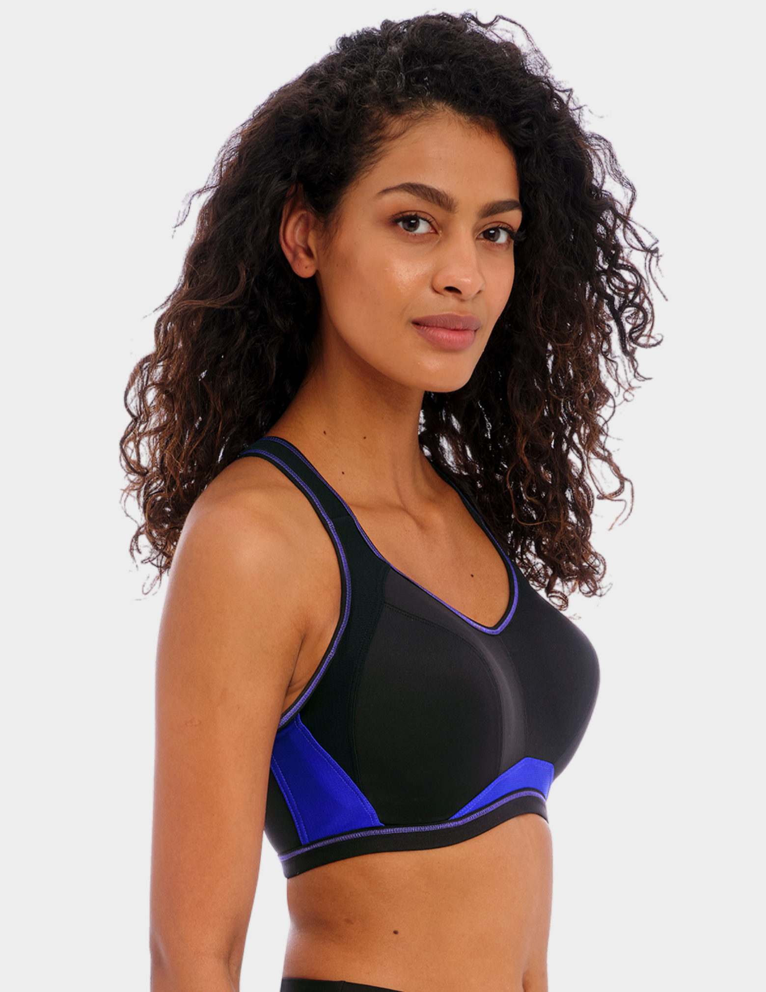 Side view of a model wearing Freya Epic sports bra in electric black
