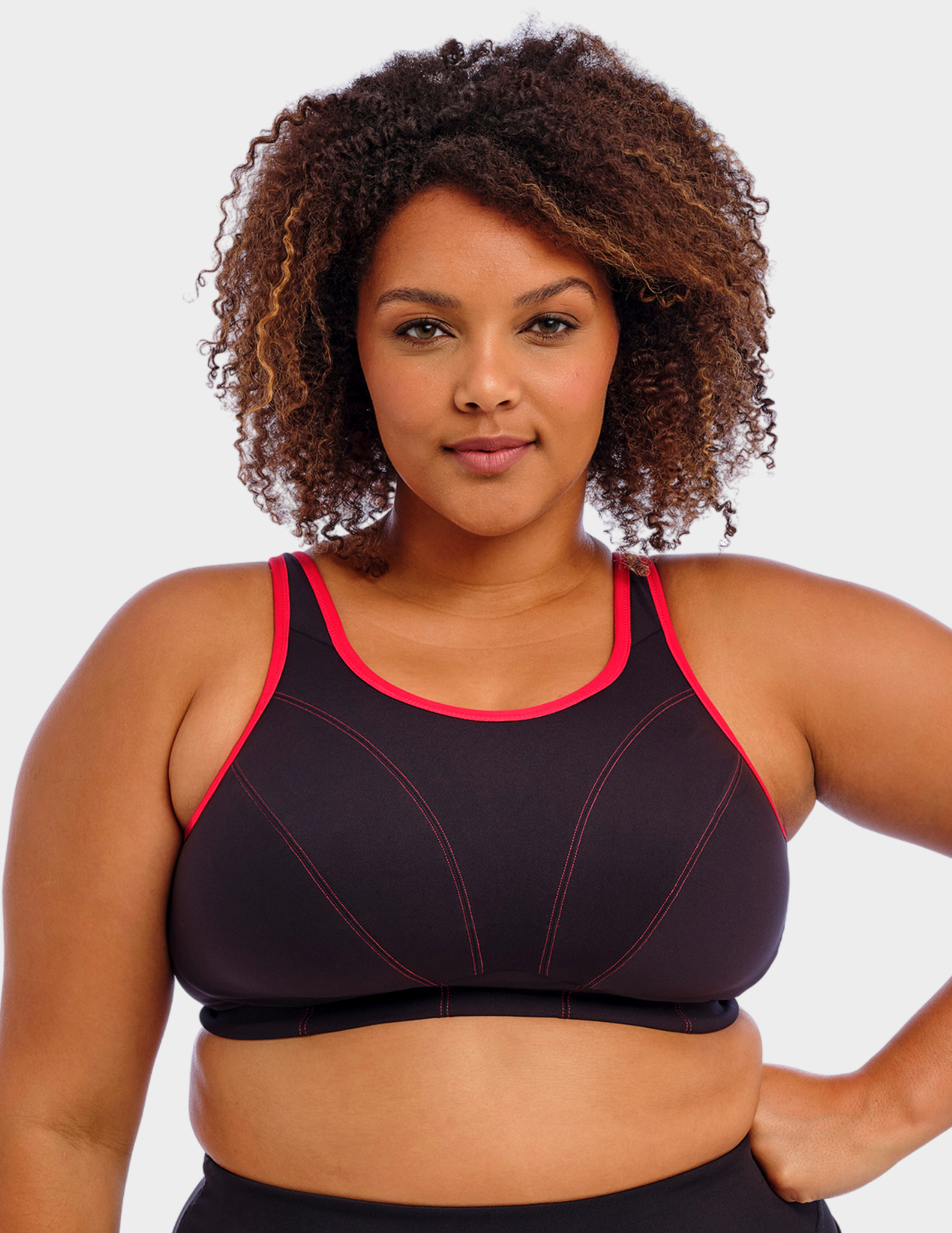 Front view of a model wearing Goddess Synergy sports bra in black