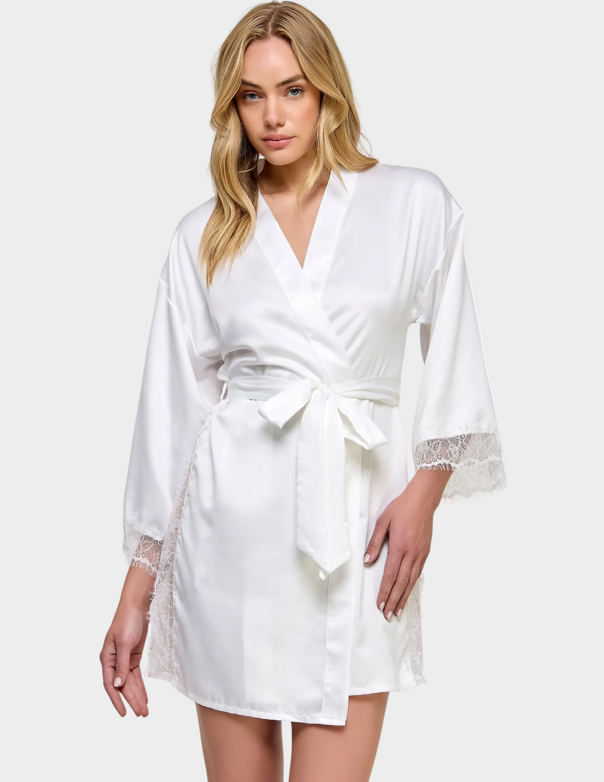 Front view of a model wearing a white satin robe with lace trim