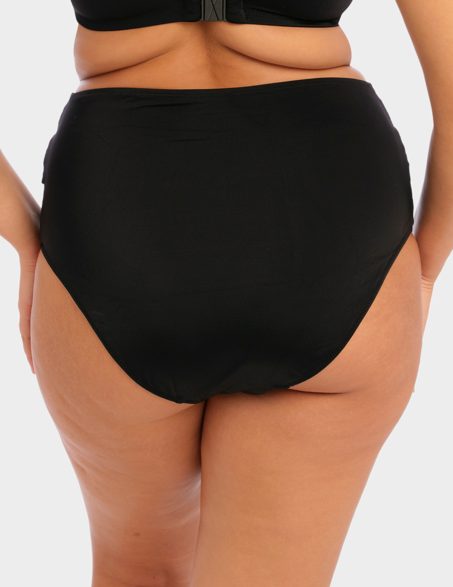 Back view of a model wearing Elomi magnetic swim brief in black