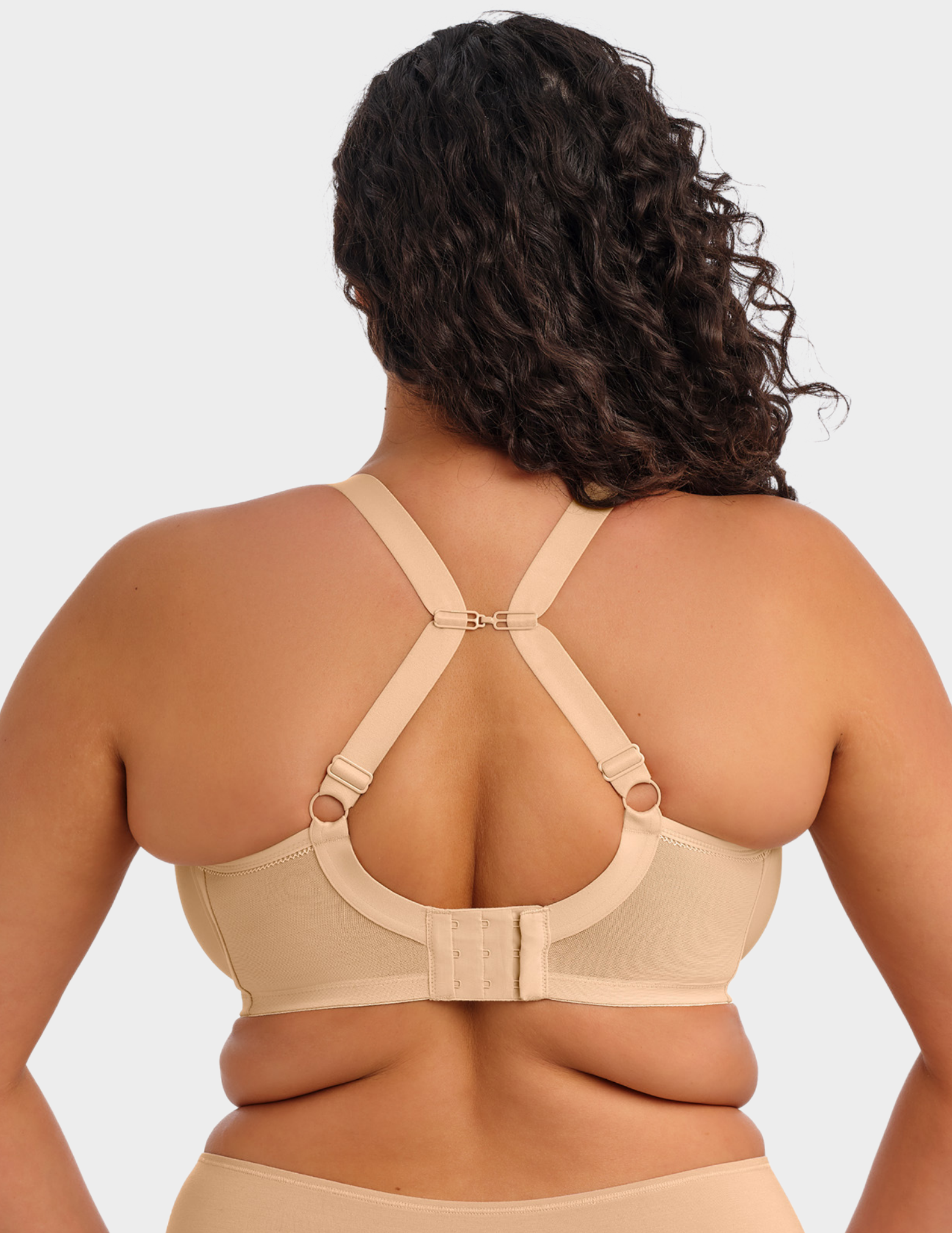 Back view of a model wearing Elomi Bijou plunge bra in sand with straps hooked